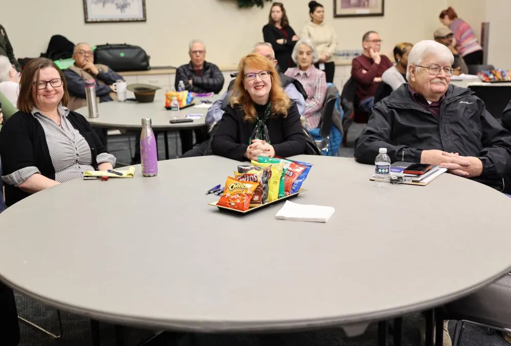 a group of people seated at round tables