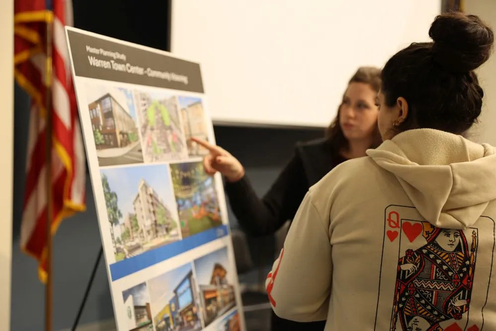 two people looking at a poster board
