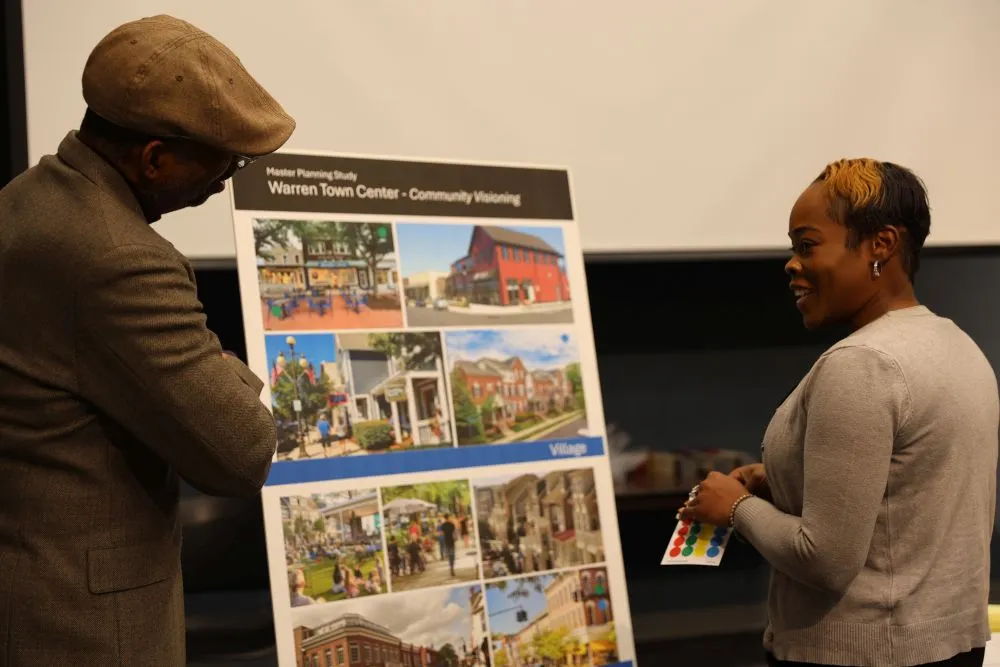 two people looking at a poster board