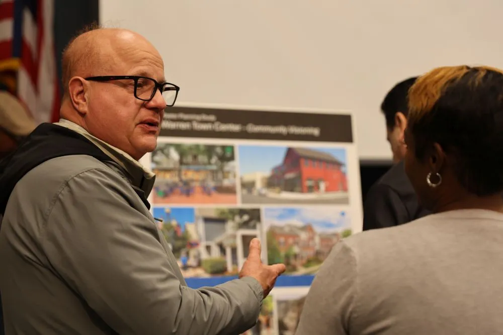 two people looking at a poster board