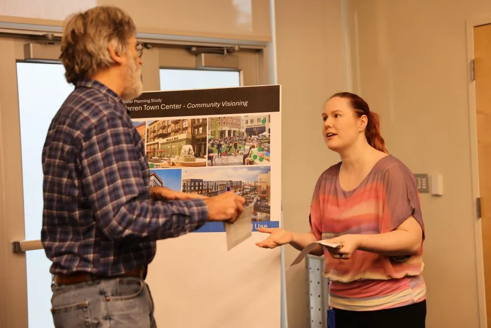 two people looking at a poster board