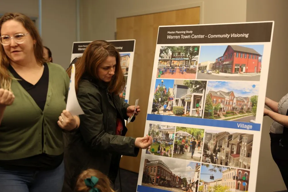 people looking at a poster board