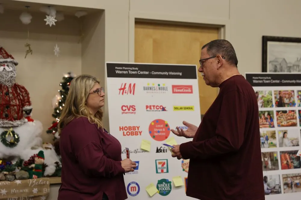 two people looking at a poster board